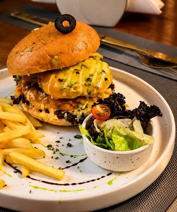 Olive Fork burger served with fries and salad