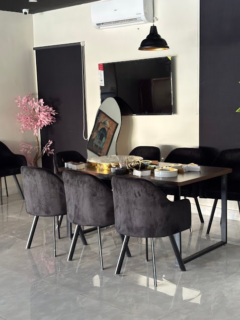 Black dining chairs, set tables and artwork inside Olive Fork
